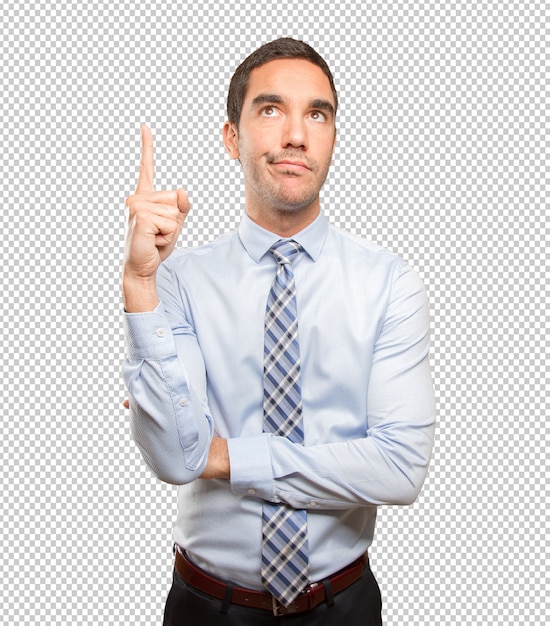 Surprised young businessman pointing up