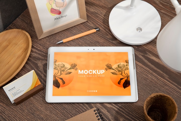 PSD tablet device mock-up on wood scene