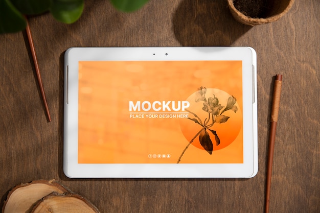 PSD tablet device mock-up on wood scene