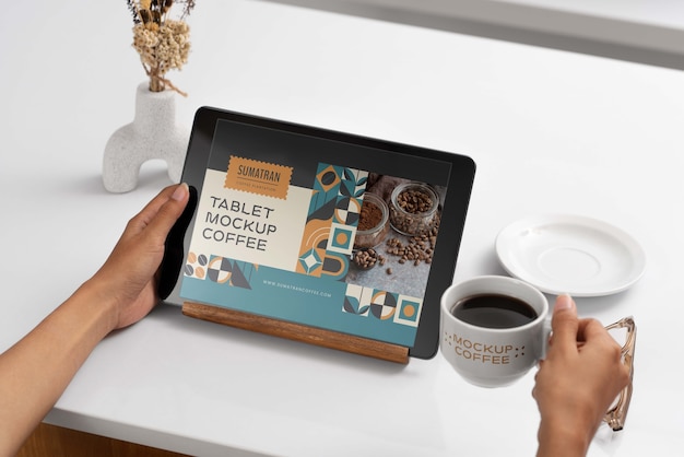 Tablet device with cup of coffee