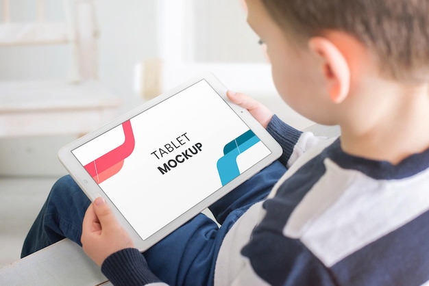 PSD tablet mockup in boy hands horizontal