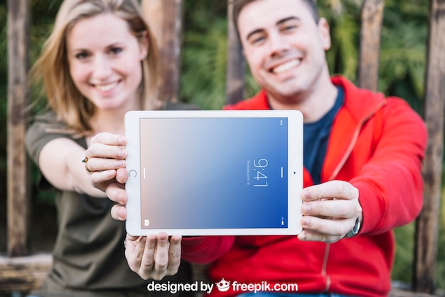 PSD tablet mockup with couple outdoors