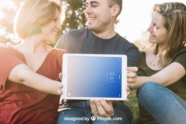 Tablet mockup with friends outdoors