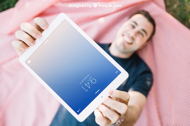 PSD tablet mockup with man lying on cloth