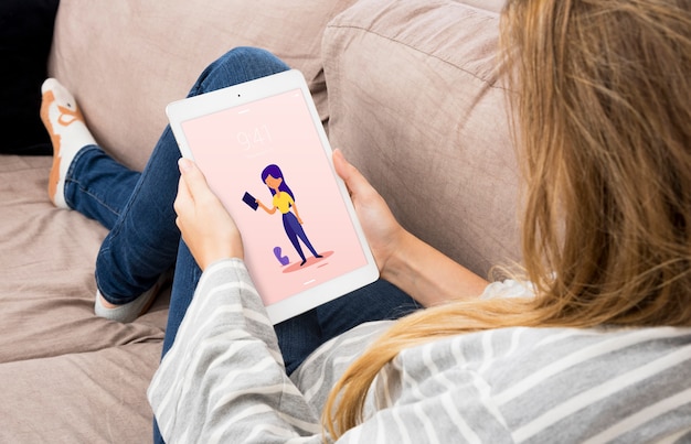 Tablet mockup with woman chilling on couch