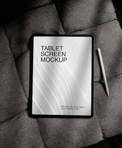 PSD a tablet screen mockup is laying on a bed.