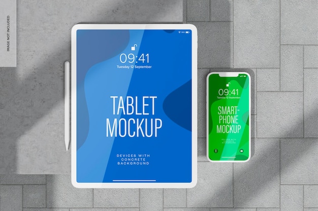 Tablet and smartphone with concrete background mockup, top view