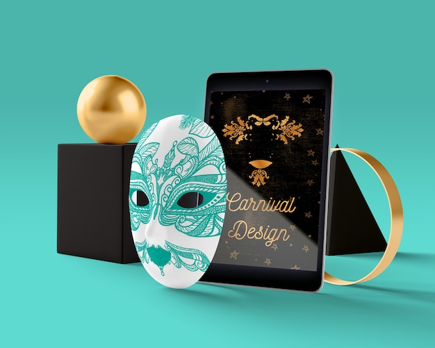 Tablet with carnival theme beside mask