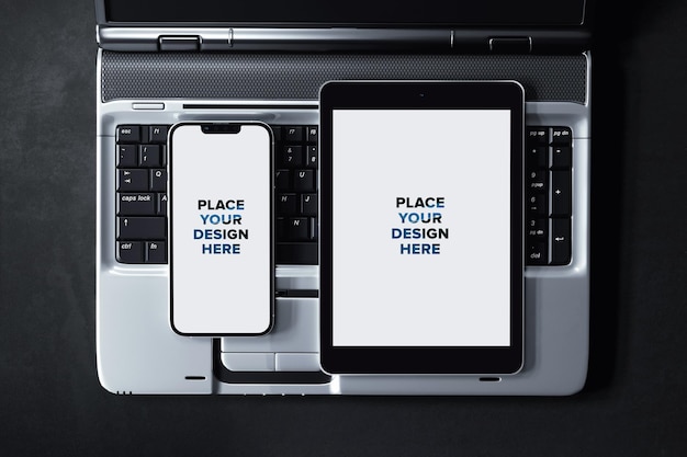 Tablet with smartphone on laptop keyboard mockup