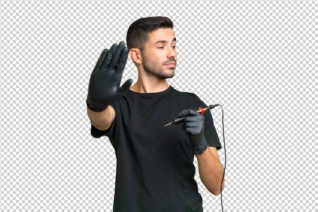 PSD tattoo artist caucasian man over isolated background making stop gesture and disappointed