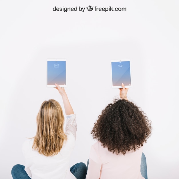 PSD technology mockup with women holding tables in air