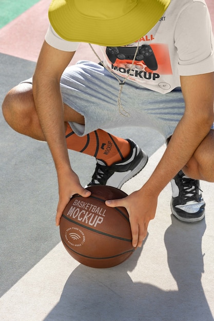 PSD teenage boy with basketball outside on the court