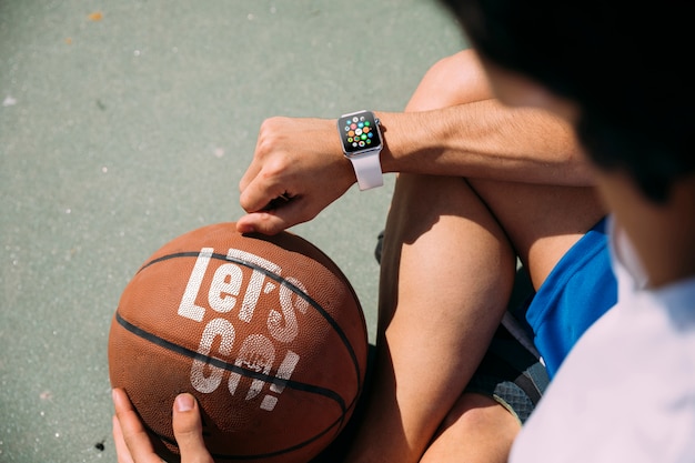 Teenager holding a basketball from behind