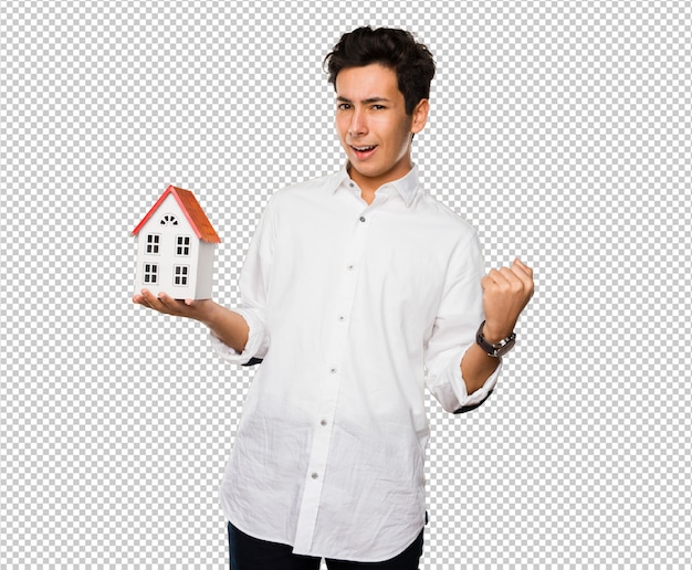 Teenager holding a house