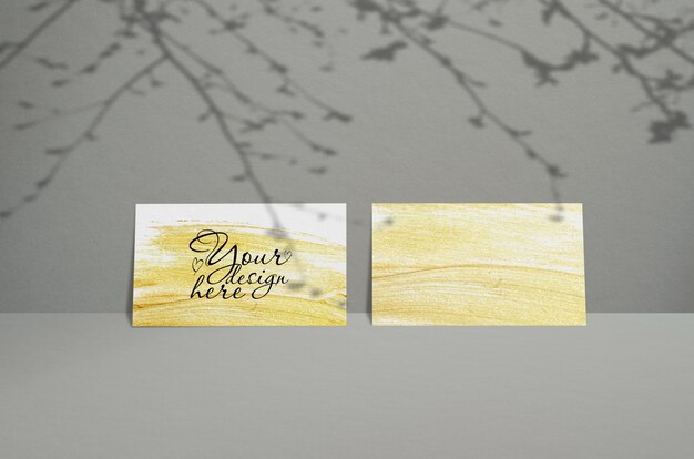 PSD template of business card on a gray background with shadow of leaves