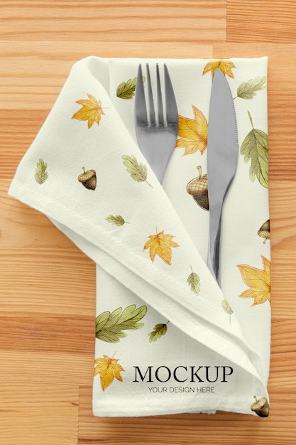 Thanksgiving dinner table arrangement with cutlery in napkin