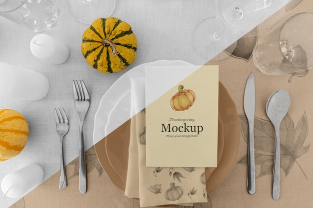 Thanksgiving dinner table arrangement with pumpkin and plates