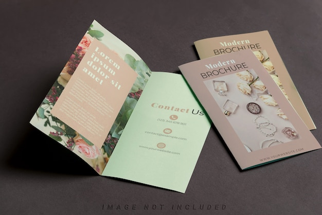three mockup brochures on black table