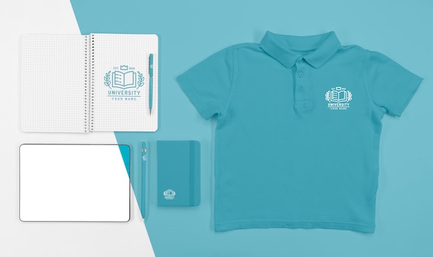 Top view of back to school t-shirt with notebooks and pen