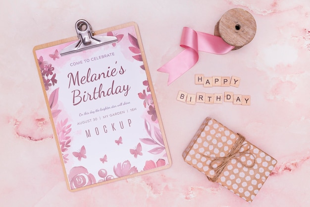 Top view of birthday notepad with gift and ribbon