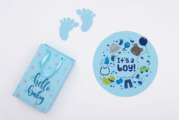 top view of blue baby shower decor with gift bag