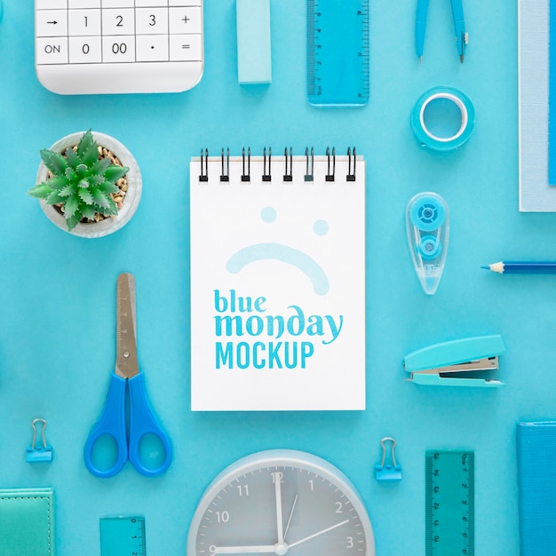 PSD top view of blue monday notebook with stationery and plant