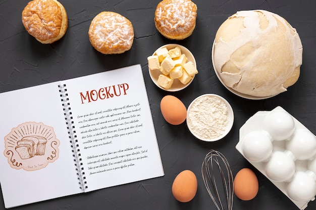 Top view of bread with ingredients and notebook