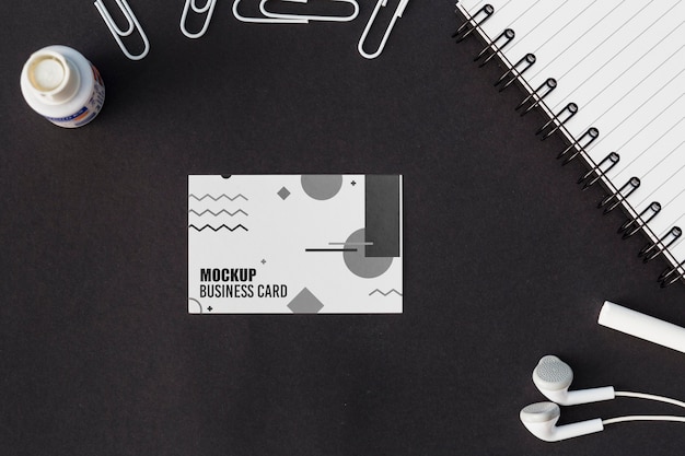 Top view of business card mock-up with earphones