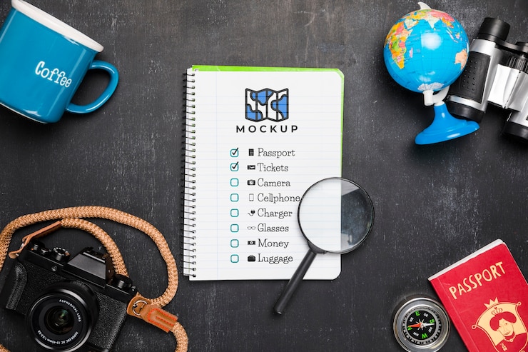 PSD top view of checklist with magnifying glass and camera for traveling