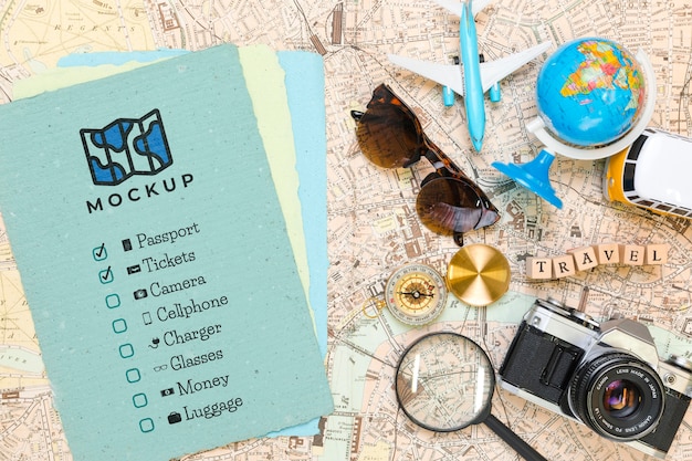 Top view of checklist with sunglasses and globe for traveling