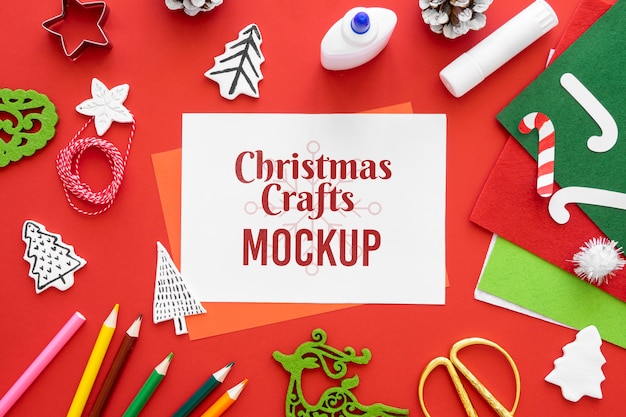 top view of christmas crafts with crayons and paper