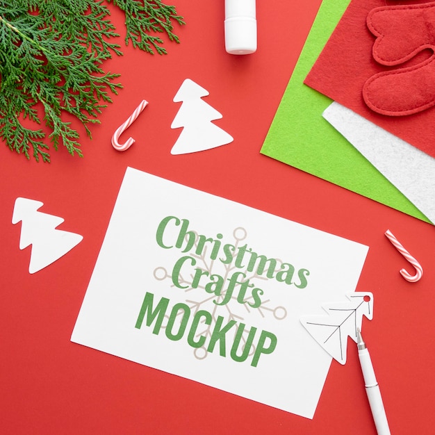 top view of christmas crafts with paper and branch