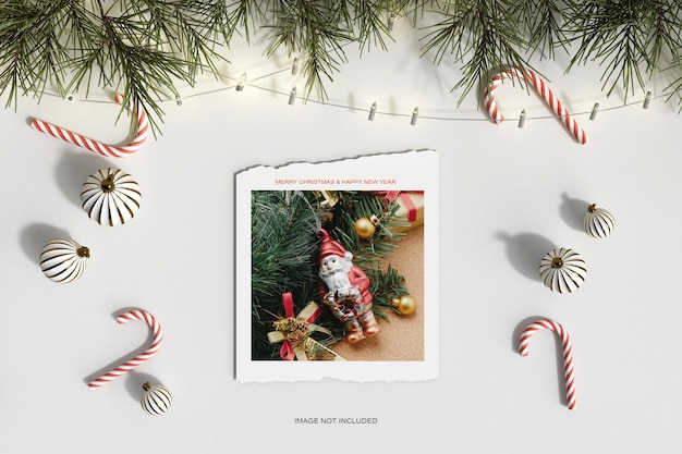 PSD top view christmas paper with pine leafs and candy mockup