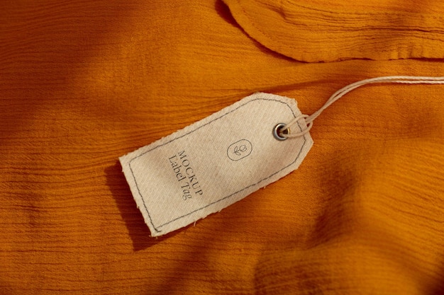 Top view of clothing label on orange textile