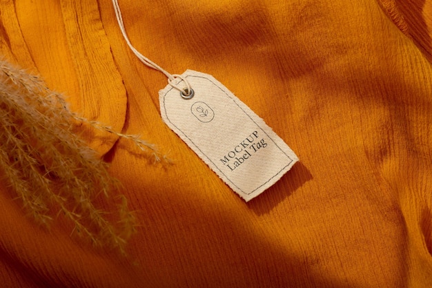 Top view of clothing label on orange textile