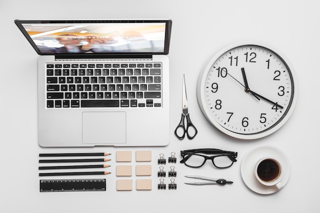 Top view composition with laptop and office supplies