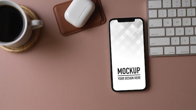 Top view of computer desk with smartphone mockup