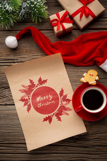 PSD top view cup of coffee with merry christmas letter and santa's hat