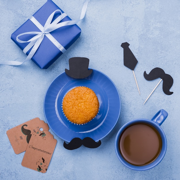 top view of cupcake on plate with coffee and gift for fathers day