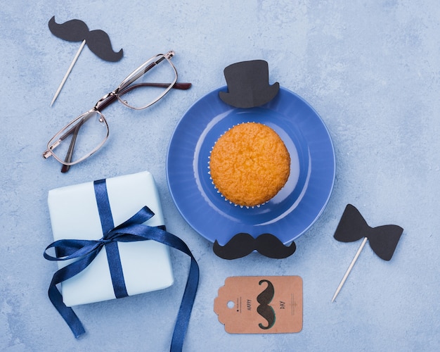 top view of cupcake with glasses and gift for fathers day