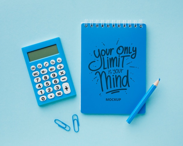 Top view of desk with calculator and pencil