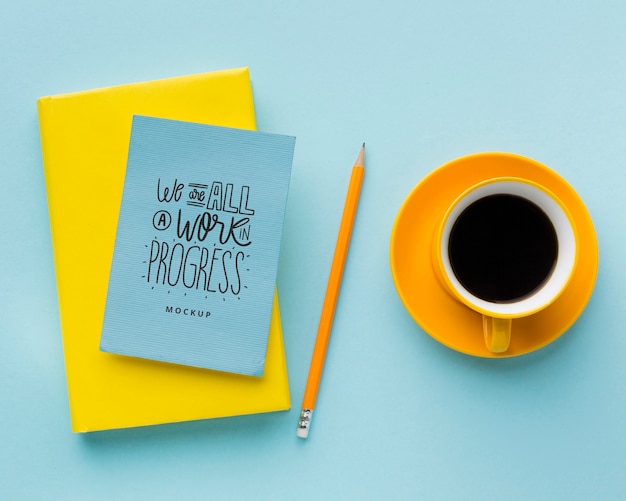 Top view of desk with coffee and notebooks