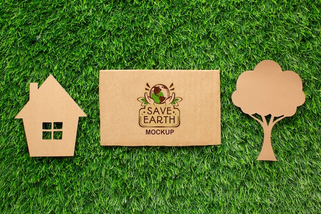 Top view eco cardboard mock-up with paper house and tree