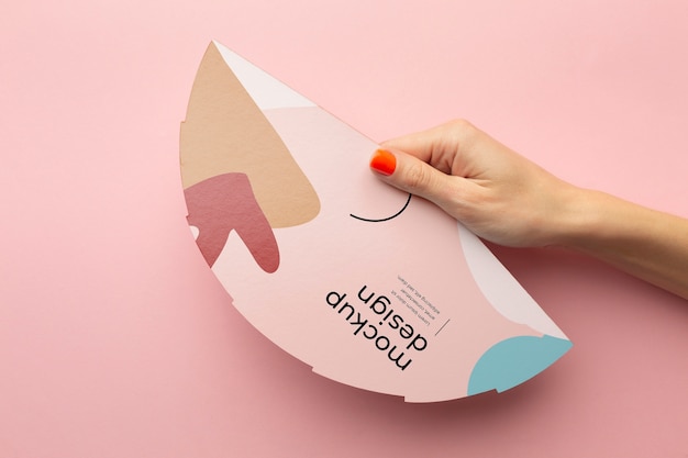 Top view of female hands holding mock-up paper fan