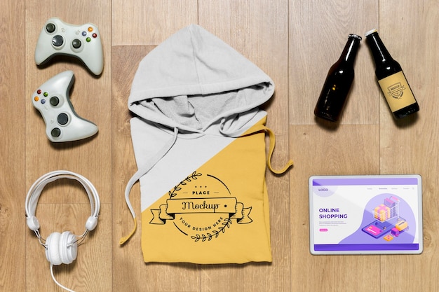 Top view folded hoodie mock-up with gadgets and bottles