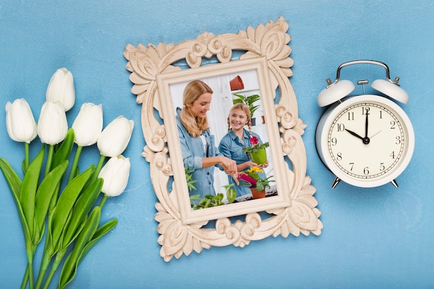 Top view of frame with clock and tulips