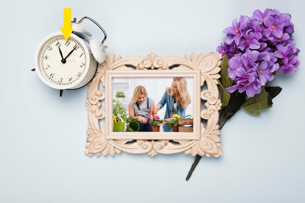 PSD top view of frame with flowers and clock