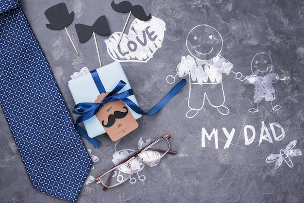 Top view of gift and tie with glasses for fathers day