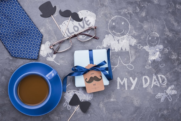 Top view of gift with coffee and tie for fathers day