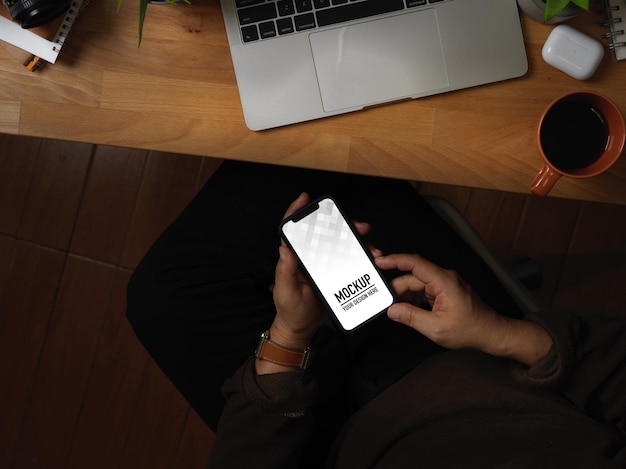 Top view of hands using smartphone mockup